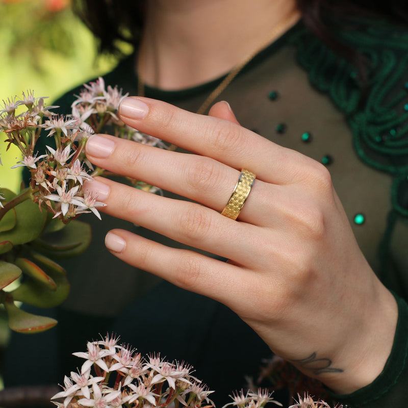 Model wearing 18k gold band with engraved basket weave pattern. Fine jewellery hand made in London  from Los Angeles designer Brooke Gregson. 