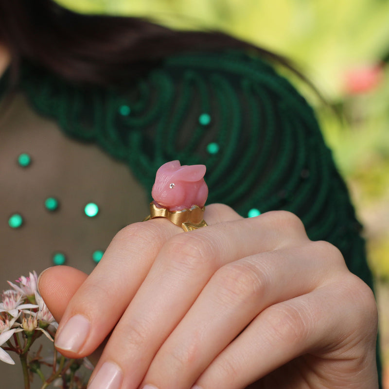 Model wearing Unique, hand engraved Pink Opal bunny ring with white diamond eyes and basket weave 18k gold band fine jewelry from Los Angeles designer Brooke Gregson.