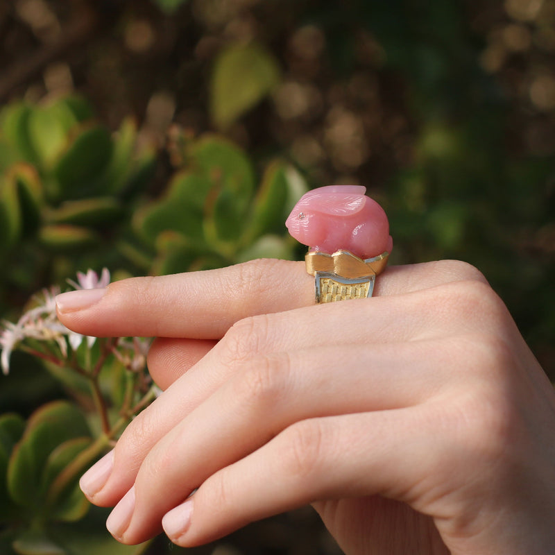 Model wearing Unique, hand engraved Pink Opal bunny ring with white diamond eyes and basket weave 18k gold band fine jewelry from Los Angeles designer Brooke Gregson.