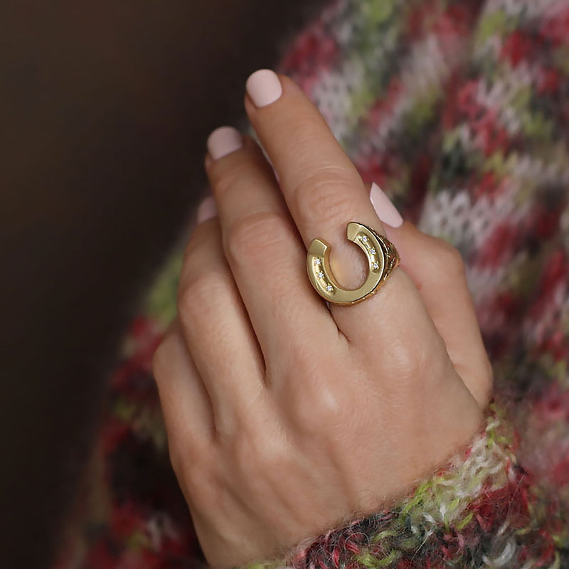 Model wearing 18k gold hand engraved horseshoe ring with diamonds by Los Angeles fine  jewelry designer Brooke Gregson.